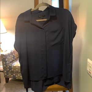 Oversized blouse button down sides front pocket.